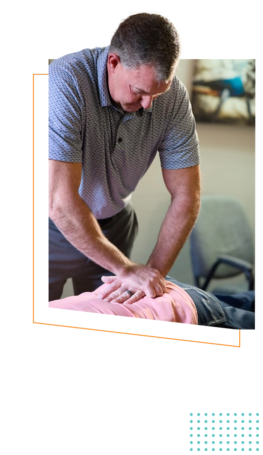 Eric Carpenter adjusting a patients back.